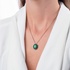 Oval emerald pendant with black diamond bezel setting