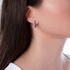 Single fashionable gold earring with dark purple enamel