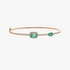 Gold bangle bracelet with diamonds and emeralds