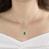 White gold emerald drop pendant with diamonds