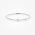 Sleek white gold bangle braacelet with diamond accents