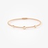 Sleek pink gold bangle bracelet with diamonds accents