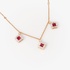 Dangling ruby squares in a pink gold necklace