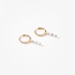 Tiny gold hoops with three dangling diamonds