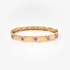 Gold bangle with pink hearts