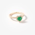 Gold heart shaped ring with an emerald and diamonds