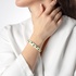 Gold bangle with emeralds and white enamel