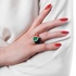 Impressive art deco ring with coral paste, diamonds and emerald