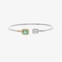 White gold bangle bracelet with an emerald and diamonds