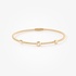 Sleek gold bangle bracelet with diamonds accents
