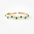 Gold bangle with emeralds and white enamel