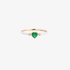 Gold ring with white enamel and a heart shaped emerald
