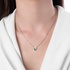 White gold drop shaped pendant with emerald
