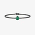 tennis bracelet with black diamonds and a pear cut emerald center