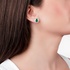 White gold emerald studs with baguette diamonds